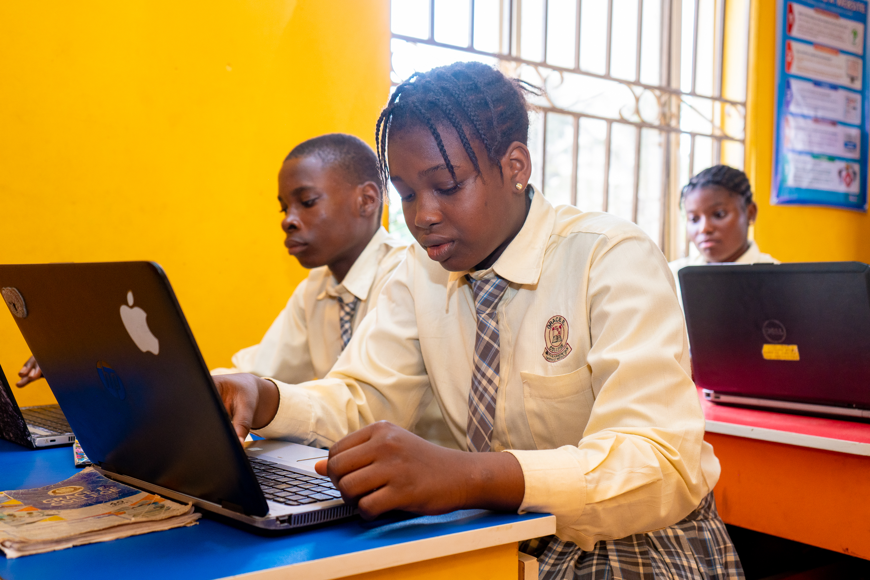A female college student learning Python programming in the computer laboratory