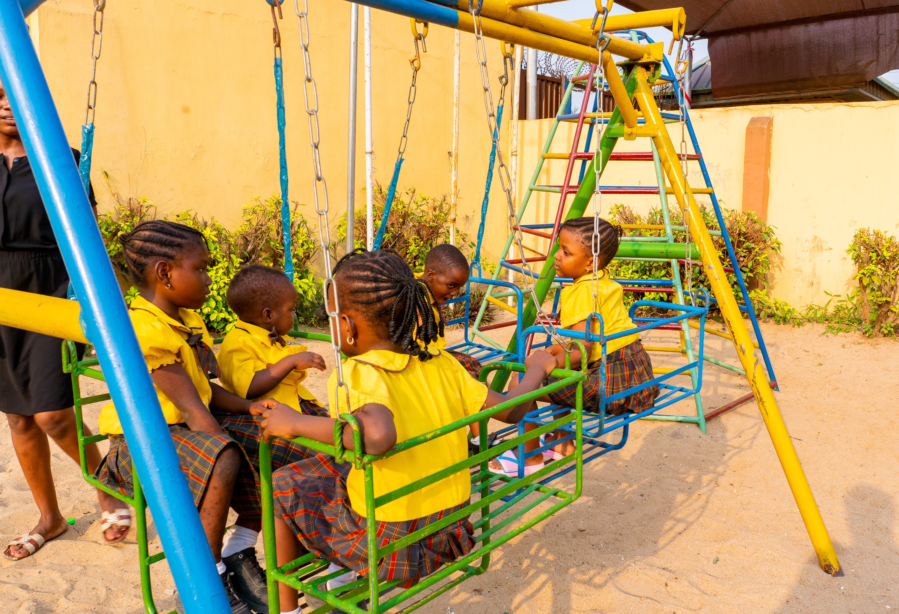 Primary pupil on a swing on the playground
