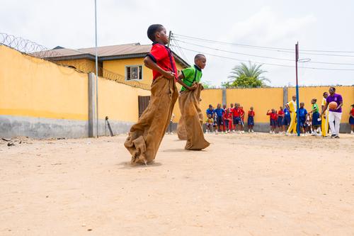 College students competing in a sack race