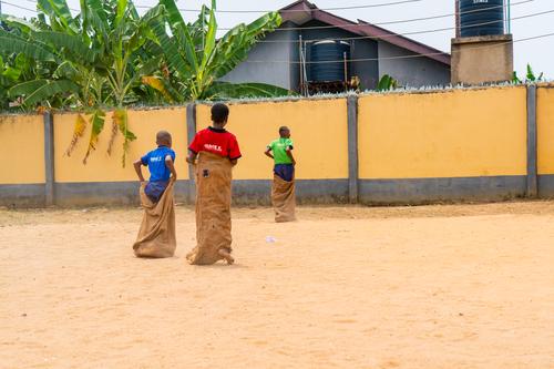 College students competing in a sack race