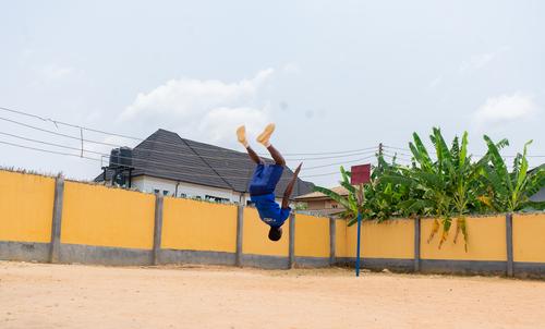 A college student performing a backflip