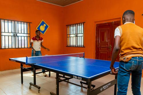 College male students playing table tennis