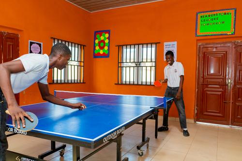 College male students playing table tennis
