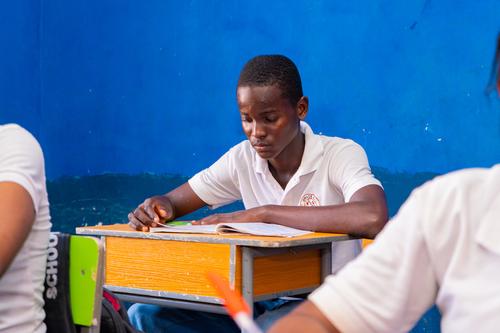 A male college student studying in the classroom