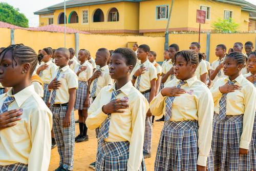 A cross-section of college students reciting the Nigerian Pledge during the assembly