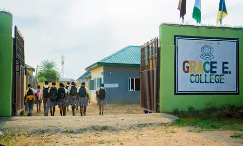 A group of college students walking towards the school gate