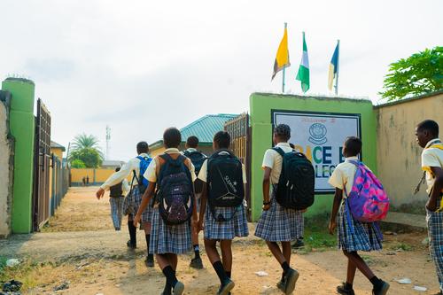 A group of college students walking towards the school gate