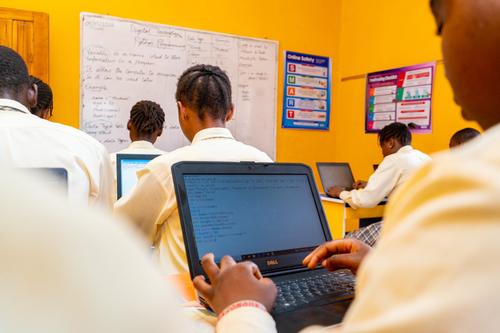 Backview of college students learning Python programming in the computer laboratory
