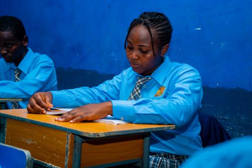 A female college student reading in the classroom