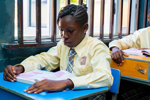 A female college student reading in the classroom