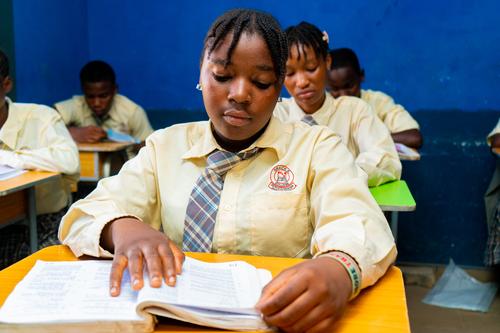 A female college student reading in the classroom