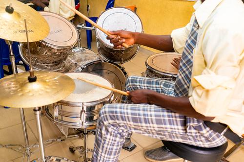 Male student playing the drums during Music class