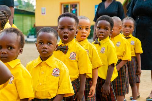 Nursery school male pupils singing during the assembly