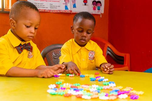 Nursery pupils interacting with ball and joint building set in the classroom