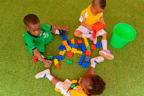 Nursery pupils learning with building blocks on the playground