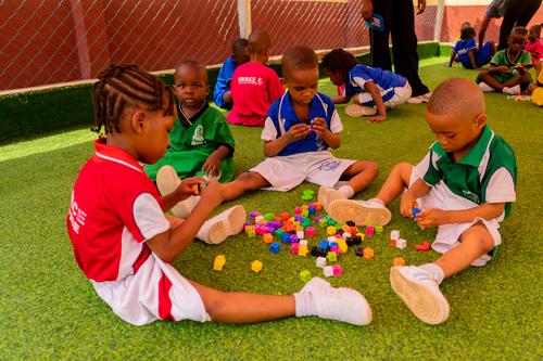 Nursery pupils learning with building blocks on the playground
