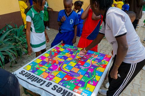 Primary students playing snakes and ladders