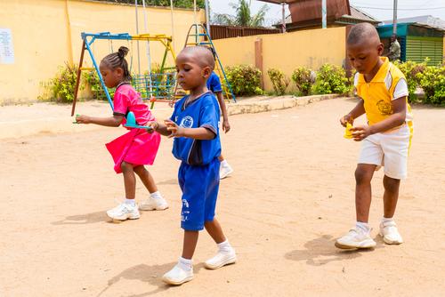 Primary students competing in an egg-and-spoon race