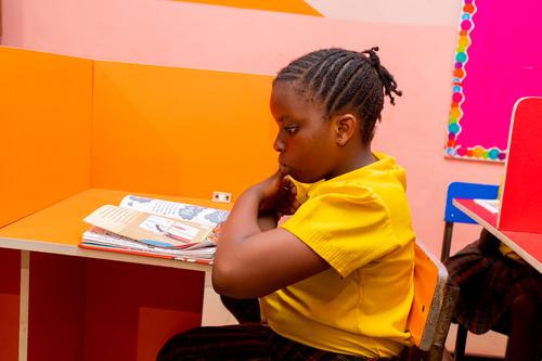 Side view of a female primary student in the school library