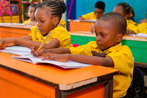 Primary pupils listening in the classroom