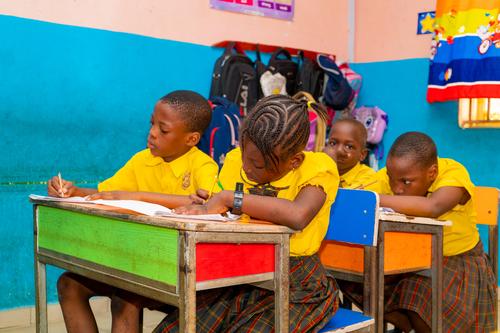 Primary pupils writing in the classroom