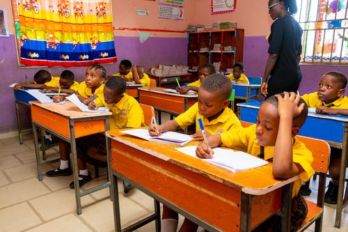 A cross-section of primary pupils writing in the classroom