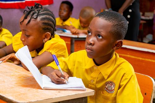 Pupils writing in the classroom